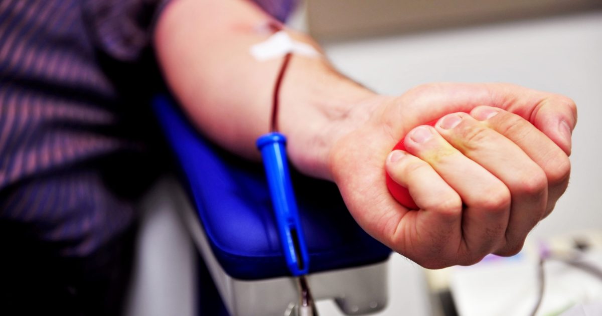 The hand of a blood donor squeezing a medical rubber ball