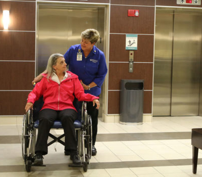 An image of a person leaving a hospital room with a suitcase, looking happy and healthy.