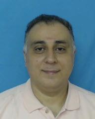 a person posing for the camera with Old Tuscaloosa County Jail in the background