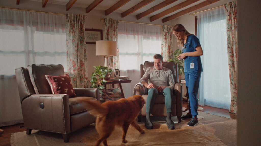 Dog and two people in living room